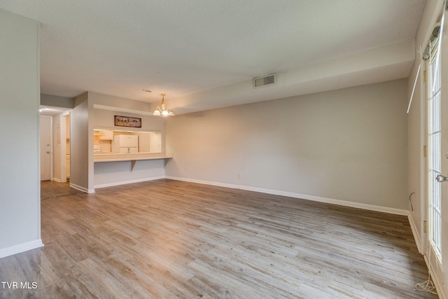 815 7th St Unit 815, Bristol, TN 37620 - unfurnished living room featuring wood finished floors and a chandelier