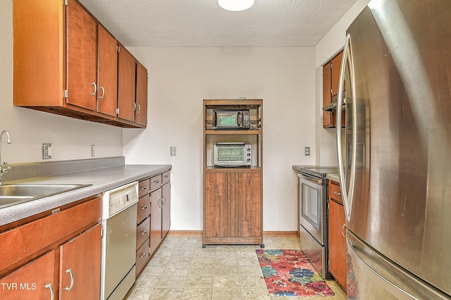 190 Sycamore Cir, Jonesborough, TN 37659 - kitchen featuring appliances with stainless steel finishes, brown cabinets, and a textured ceiling