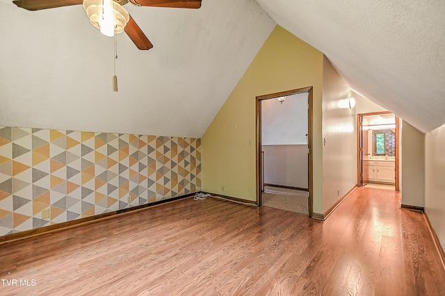190 Sycamore Cir, Jonesborough, TN 37659 - additional living space featuring wood finished floors, a ceiling fan, an accent wall, vaulted ceiling, and a textured ceiling