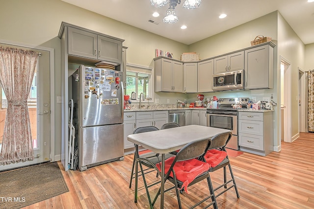 190 Sycamore Cir, Jonesborough, TN 37659 - kitchen with appliances with stainless steel finishes, gray cabinets, light wood-type flooring, recessed lighting, and a chandelier