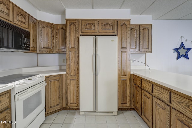 1710 Sundale Rd, Johnson City, TN 37604 - kitchen featuring white appliances, brown cabinets, light countertops, and light tile patterned floors