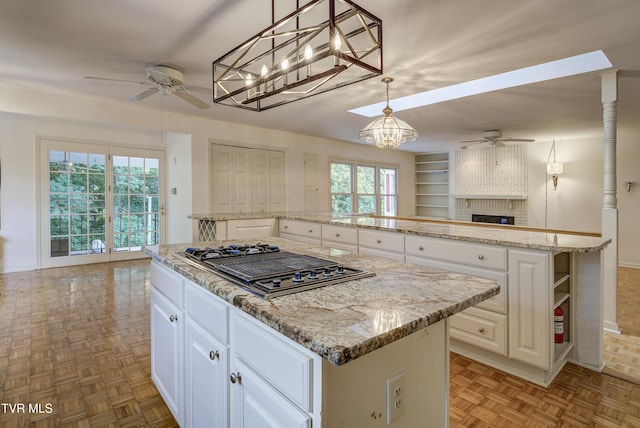 1710 Sundale Rd, Johnson City, TN 37604 - kitchen featuring ceiling fan, a kitchen island, and stainless steel gas cooktop