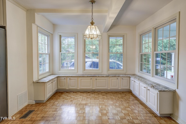 1710 Sundale Rd, Johnson City, TN 37604 - unfurnished dining area with a chandelier, healthy amount of natural light, and beamed ceiling
