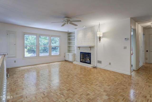 1710 Sundale Rd, Johnson City, TN 37604 - unfurnished living room featuring ceiling fan, built in features, and a brick fireplace