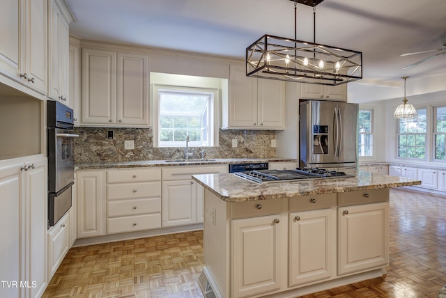 1710 Sundale Rd, Johnson City, TN 37604 - kitchen with appliances with stainless steel finishes, a kitchen island, decorative backsplash, a warming drawer, and a chandelier