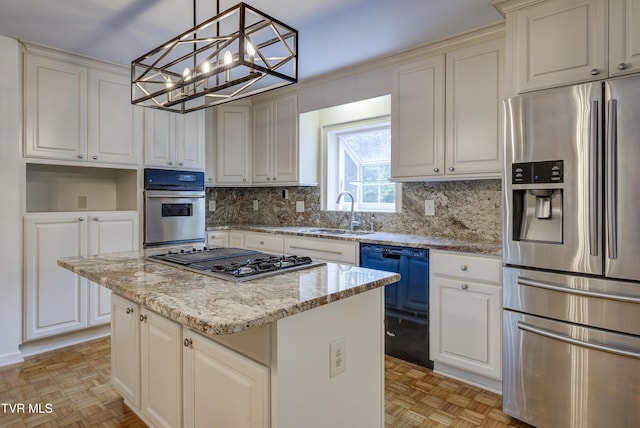 1710 Sundale Rd, Johnson City, TN 37604 - kitchen featuring appliances with stainless steel finishes, tasteful backsplash, a center island, light stone counters, and a chandelier