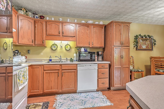 929 Cornerstone Ct, Kingsport, TN 37660 - kitchen featuring white appliances, light wood-style floors, light countertops, brown cabinets, and a textured ceiling