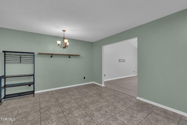 46 Taylor Ridge Ct, Johnson City, TN 37601 - spare room with a chandelier, a textured ceiling, and tile patterned flooring