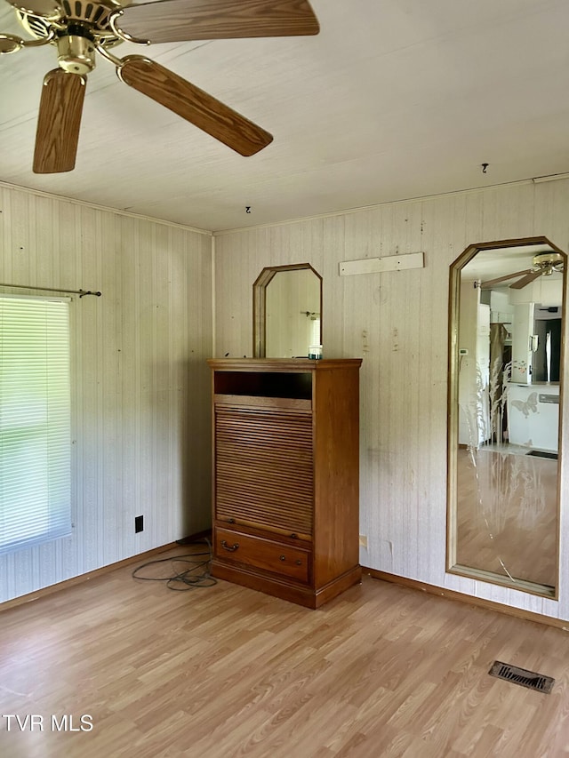 2703 Orr St, Big Stone Gap, VA 24219 - unfurnished living room with a ceiling fan, wood finished floors, wooden walls, and arched walkways