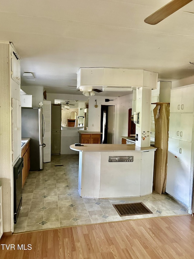 2703 Orr St, Big Stone Gap, VA 24219 - kitchen featuring a peninsula, freestanding refrigerator, light wood finished floors, and ceiling fan