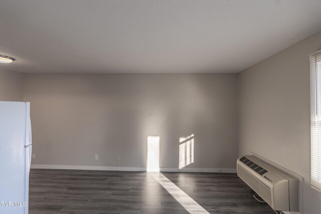 105 Lemay Dr, Kingsport, TN 37664 - empty room with dark wood-type flooring and a wall mounted air conditioner