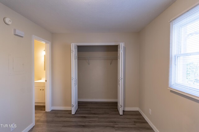 105 Lemay Dr, Kingsport, TN 37664 - unfurnished bedroom with multiple windows, dark wood-style floors, and a closet