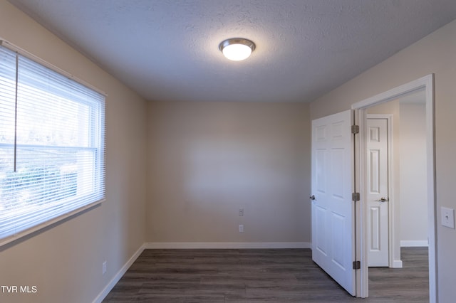 105 Lemay Dr, Kingsport, TN 37664 - empty room featuring healthy amount of natural light, dark wood-style floors, and a textured ceiling