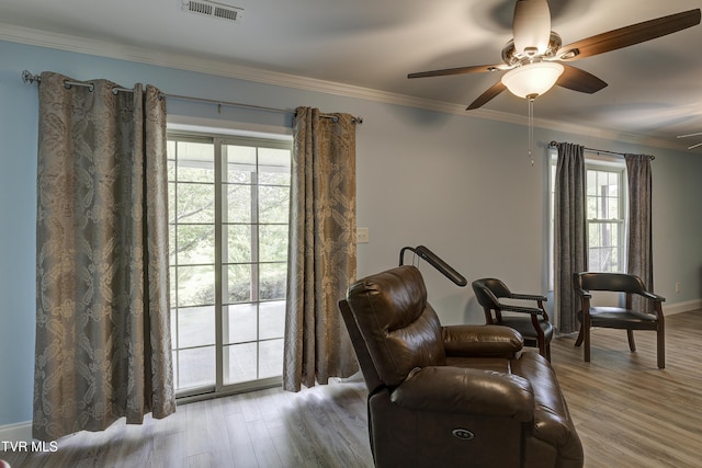 2146 Buttercup Ln, Limestone, TN 37681 - living area featuring healthy amount of natural light, ceiling fan, ornamental molding, and wood finished floors