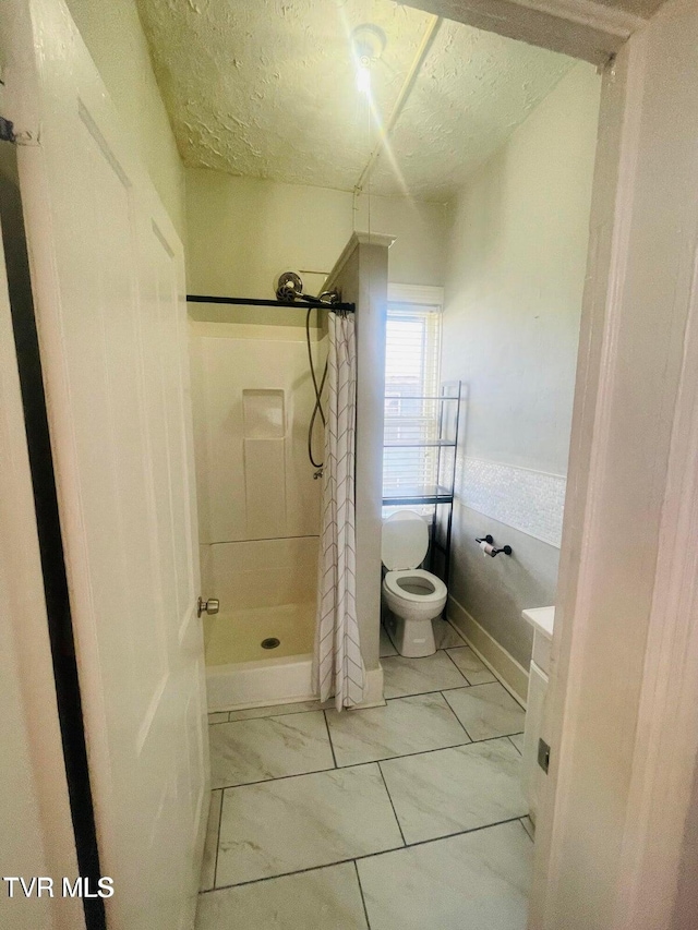 402 E Unaka Ave, Johnson City, TN 37601 - bathroom featuring a shower stall, a textured ceiling, and vanity