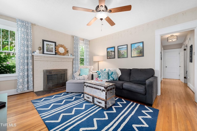 922 W Hillcrest Dr, Johnson City, TN 37604 - living area featuring wood finished floors, a brick fireplace, and ceiling fan