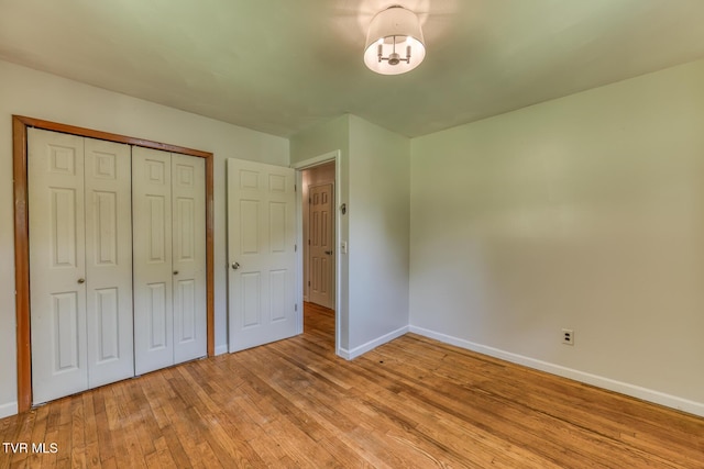 224 Meadow Dr, Bristol, TN 37620 - unfurnished bedroom featuring light wood-style floors, a closet, and a chandelier