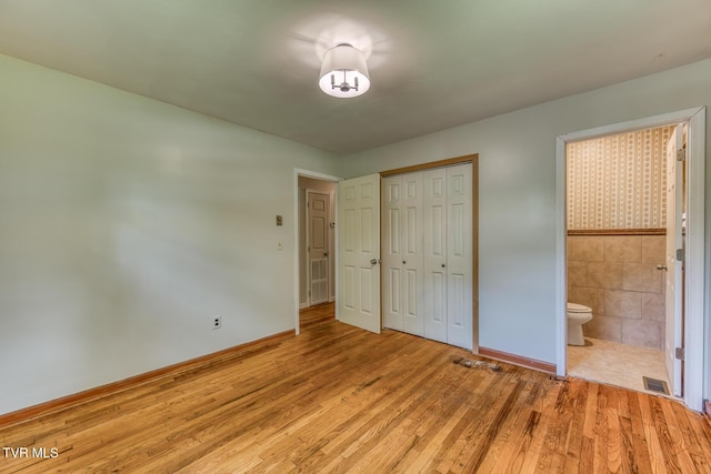 224 Meadow Dr, Bristol, TN 37620 - unfurnished bedroom featuring light wood-style floors, a closet, and connected bathroom