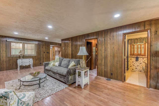 224 Meadow Dr, Bristol, TN 37620 - living area with wood finished floors, wood walls, recessed lighting, and a textured ceiling