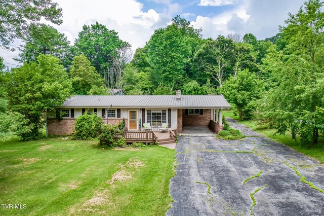 224 Meadow Dr, Bristol, TN 37620 - ranch-style house featuring driveway, brick siding, a metal roof, and a front lawn