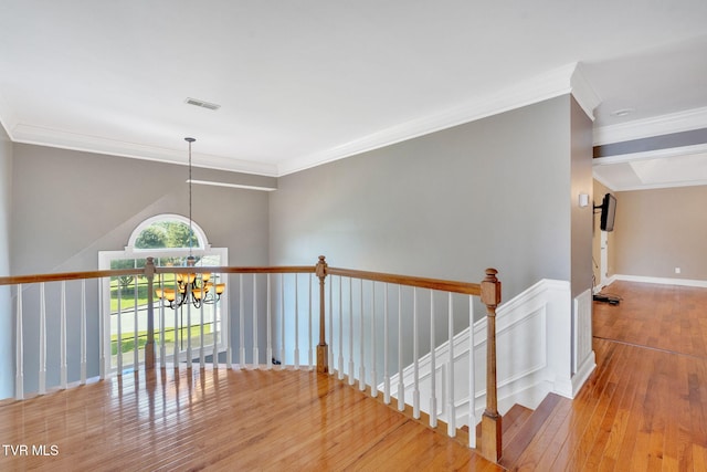 504 Amelia Ct, Blountville, TN 37617 - hallway with wood-type flooring, ornamental molding, an upstairs landing, and a chandelier