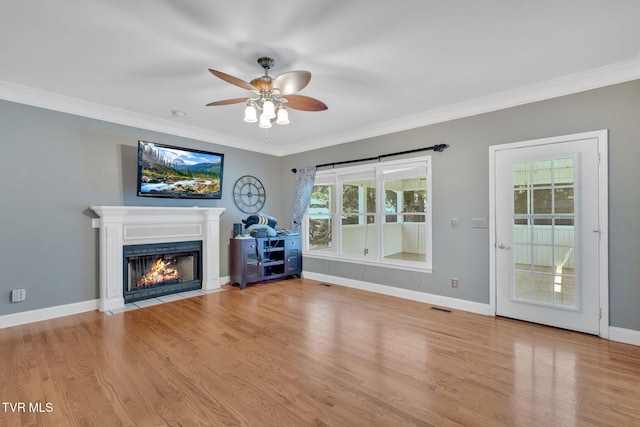 504 Amelia Ct, Blountville, TN 37617 - unfurnished living room featuring ceiling fan, a fireplace with flush hearth, wood finished floors, and ornamental molding