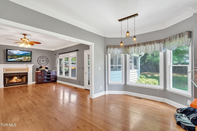 504 Amelia Ct, Blountville, TN 37617 - unfurnished living room featuring crown molding, wood finished floors, a warm lit fireplace, and ceiling fan