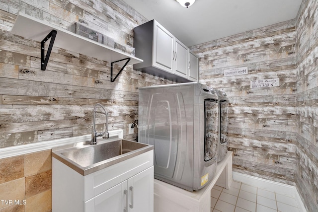 504 Amelia Ct, Blountville, TN 37617 - washroom with wooden walls, cabinet space, light tile patterned floors, and washer and dryer