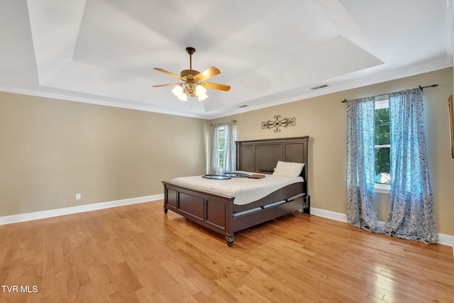 504 Amelia Ct, Blountville, TN 37617 - bedroom featuring a tray ceiling, multiple windows, light wood-style flooring, and crown molding