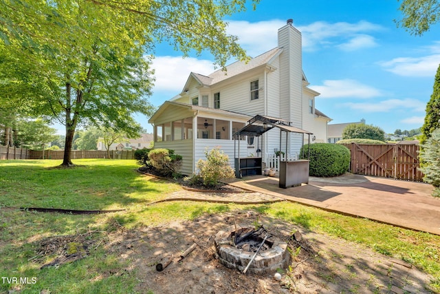 504 Amelia Ct, Blountville, TN 37617 - back of property with an outdoor fire pit, a sunroom, a fenced backyard, and a patio area