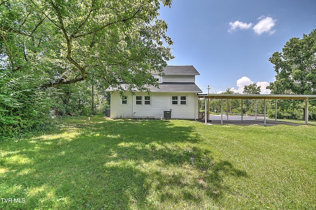 1010 Gibson Mill Rd, Kingsport, TN 37660 - back of property featuring a yard, a carport, and roof with shingles
