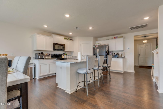 1233 Stamp Lodge Rd, Kingsport, TN 37660 - kitchen with black appliances, dark wood-type flooring, white cabinets, a breakfast bar, and recessed lighting