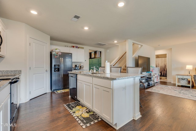 1233 Stamp Lodge Rd, Kingsport, TN 37660 - kitchen with black appliances, dark wood-style flooring, white cabinets, a kitchen island with sink, and recessed lighting