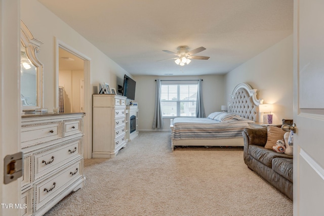 1233 Stamp Lodge Rd, Kingsport, TN 37660 - bedroom with light colored carpet, a glass covered fireplace, and a ceiling fan