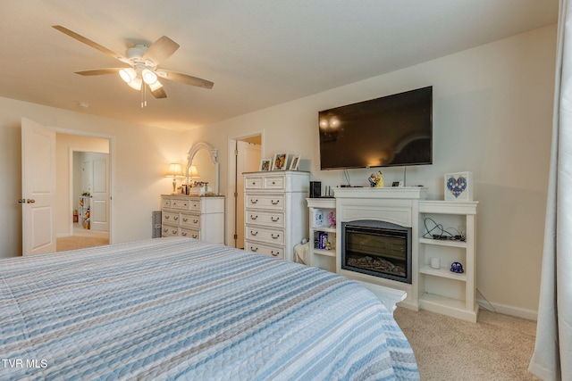 1233 Stamp Lodge Rd, Kingsport, TN 37660 - bedroom with light colored carpet, a glass covered fireplace, and ceiling fan