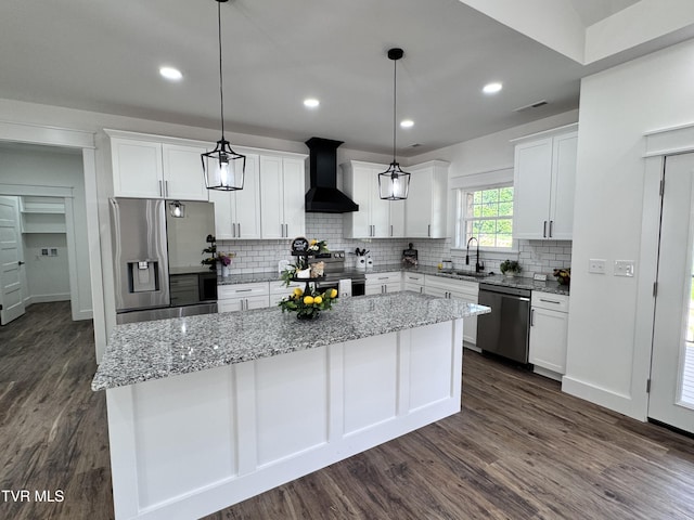 816 Hairetown Rd, Jonesborough, TN 37659 - kitchen featuring stainless steel appliances, wall chimney exhaust hood, a center island, dark wood finished floors, and recessed lighting