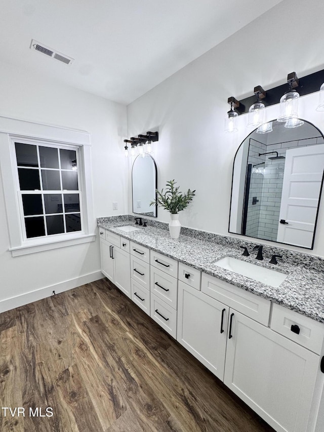 816 Hairetown Rd, Jonesborough, TN 37659 - full bath featuring double vanity, wood finished floors, and a shower stall