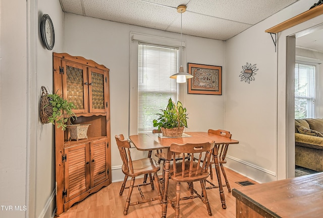 116 Esther St, Bristol, TN 37620 - dining space with light wood-style floors, a paneled ceiling, and plenty of natural light