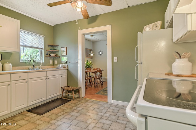 116 Esther St, Bristol, TN 37620 - kitchen featuring white appliances, a ceiling fan, white cabinets, brick patterned flooring, and light countertops