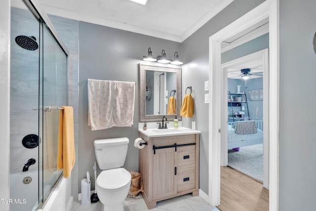 8202 Westland Dr, Knoxville, TN 37919 - bathroom featuring crown molding, vanity, bath / shower combo with glass door, and a ceiling fan
