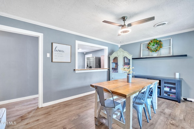 8202 Westland Dr, Knoxville, TN 37919 - dining room featuring wood finished floors, a textured ceiling, ceiling fan, and ornamental molding