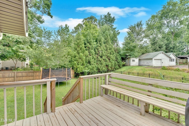 8202 Westland Dr, Knoxville, TN 37919 - wooden terrace with a trampoline, a fenced backyard, a detached garage, and view of scattered trees