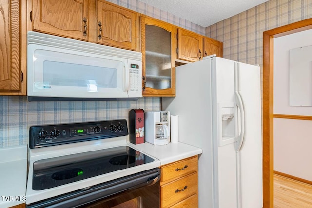 780 Hamilton Rd Unit E6, Blountville, TN 37617 - kitchen with white appliances, wallpapered walls, light countertops, brown cabinetry, and light wood-style floors