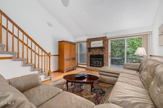 780 Hamilton Rd Unit E6, Blountville, TN 37617 - living area featuring light wood-style flooring, stairs, a stone fireplace, and high vaulted ceiling