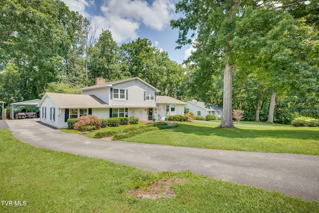 1605 Woodmont Dr, Johnson City, TN 37601 - view of front of house with a chimney, a carport, driveway, a front yard, and view of scattered trees