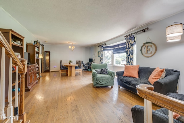 1605 Woodmont Dr, Johnson City, TN 37601 - living room with ornamental molding, a chandelier, light wood finished floors, and a textured ceiling
