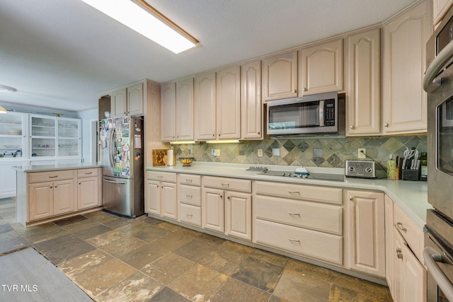 1605 Woodmont Dr, Johnson City, TN 37601 - kitchen featuring appliances with stainless steel finishes, stone tile flooring, backsplash, and light countertops