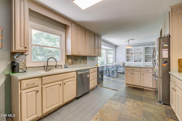 1605 Woodmont Dr, Johnson City, TN 37601 - kitchen featuring appliances with stainless steel finishes, stone tile flooring, light countertops, wine cooler, and decorative light fixtures