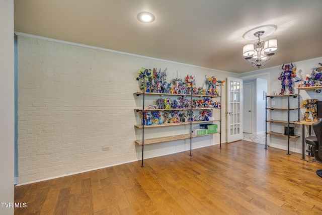 1605 Woodmont Dr, Johnson City, TN 37601 - misc room with brick wall, wood finished floors, and a chandelier