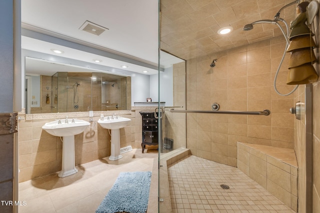 1605 Woodmont Dr, Johnson City, TN 37601 - bathroom featuring tile walls, a shower stall, tile patterned floors, and recessed lighting